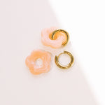 Matte peach daisy hoop earrings with removable flowers and gold hoop.