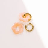 Matte peach daisy hoop earrings with removable flowers and gold hoop.