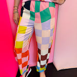 Colorful checkered pants with bright geometric print and elastic waistband.