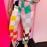 Colorful checkered pants with bright geometric print and elastic waistband.