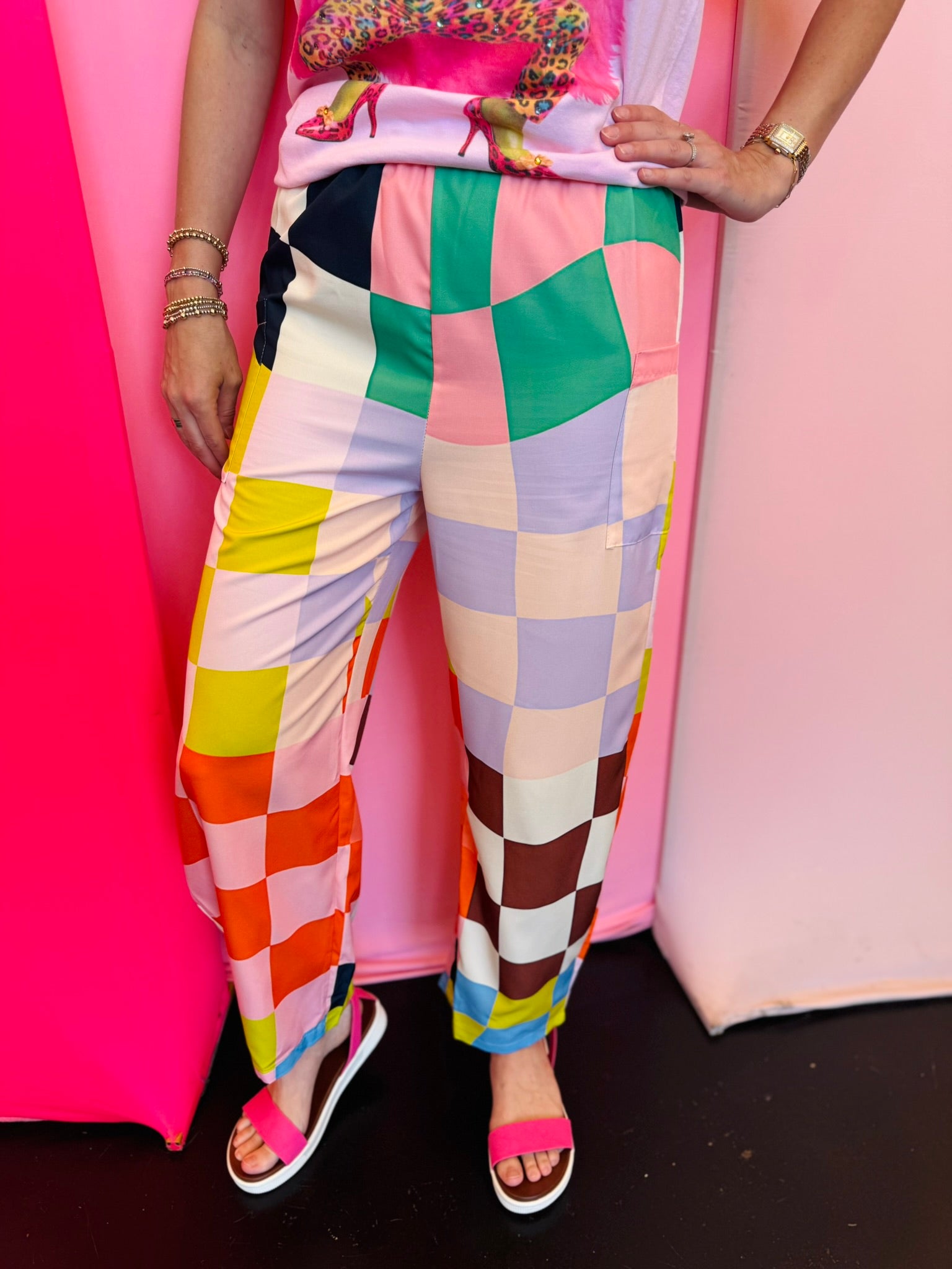 Colorful checkered pants with bright geometric print and elastic waistband.