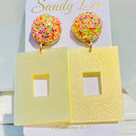 Yellow glitter square earrings with sparkling multicolor confetti-style round studs.