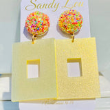 Yellow glitter square earrings with sparkling multicolor confetti-style round studs.