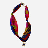 Colorful abstract polka dot scarf necklace with blue heart charm and gold chain extender.