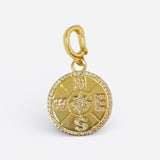 Gold compass charm with starburst center, pavé crystal edge, and lobster clasp for versatile wear