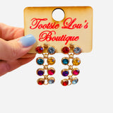 Multicolored cascading gem drop earrings in gold setting with vibrant stones.