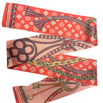 Coral chain print scarf tie styled as necklace, neck tie, or bag accessory.
