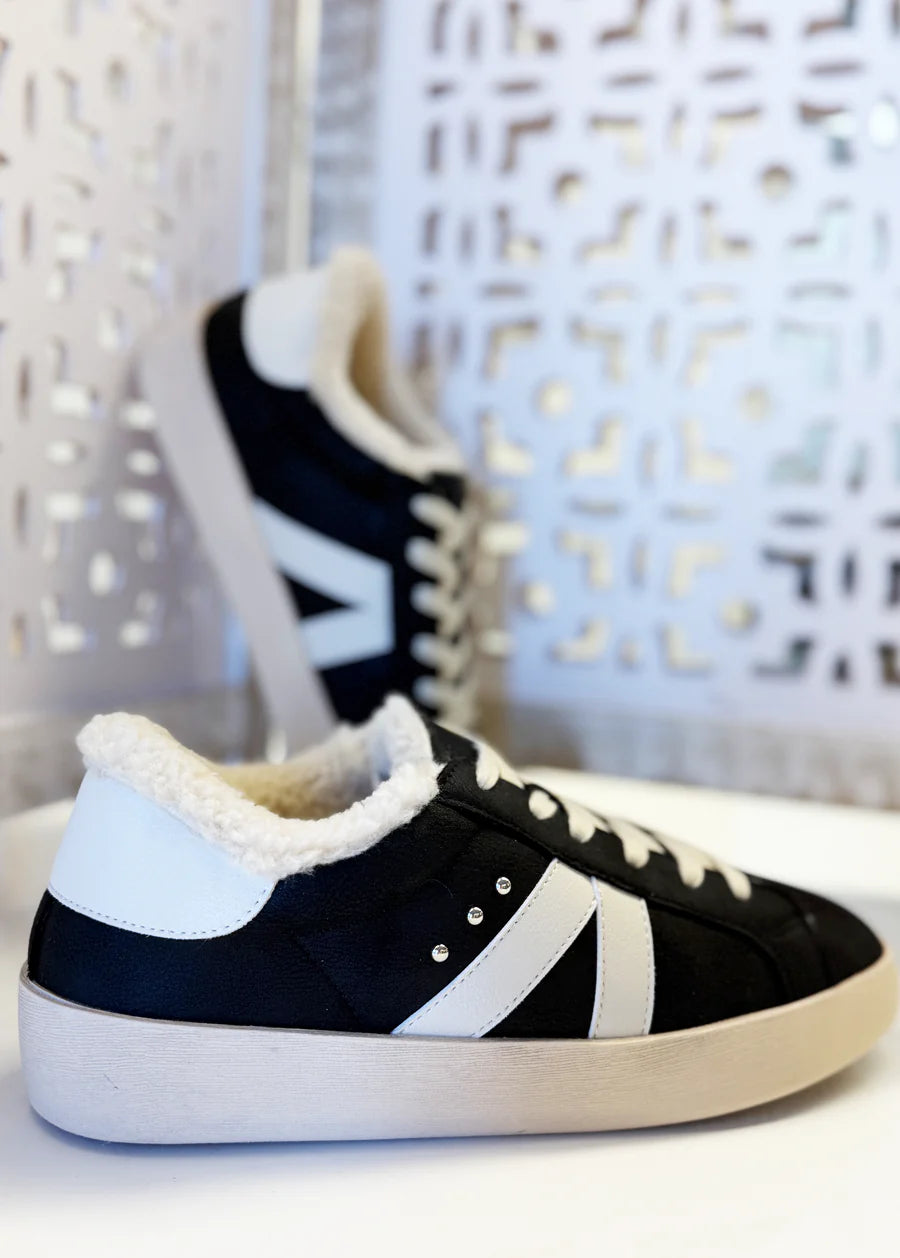 Black sherpa-lined sneakers with white accents, lace-up design, and cushioned sole for everyday comfort