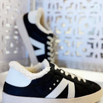 Black sherpa-lined sneakers with white accents, lace-up design, and cushioned sole for everyday comfort