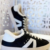 Black sherpa-lined sneakers with white accents, lace-up design, and cushioned sole for everyday comfort