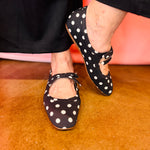 Black and white polka dot slip-on flats with cushioned insoles.