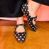 Black and white polka dot slip-on flats with cushioned insoles.