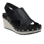Black wedge sandals with slingback strap and studded sole detail.