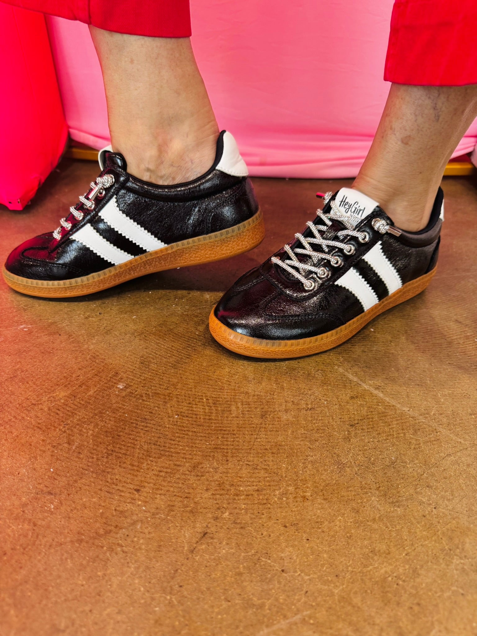 Black metallic Corky's sneakers with white side stripes and lace-up closure.