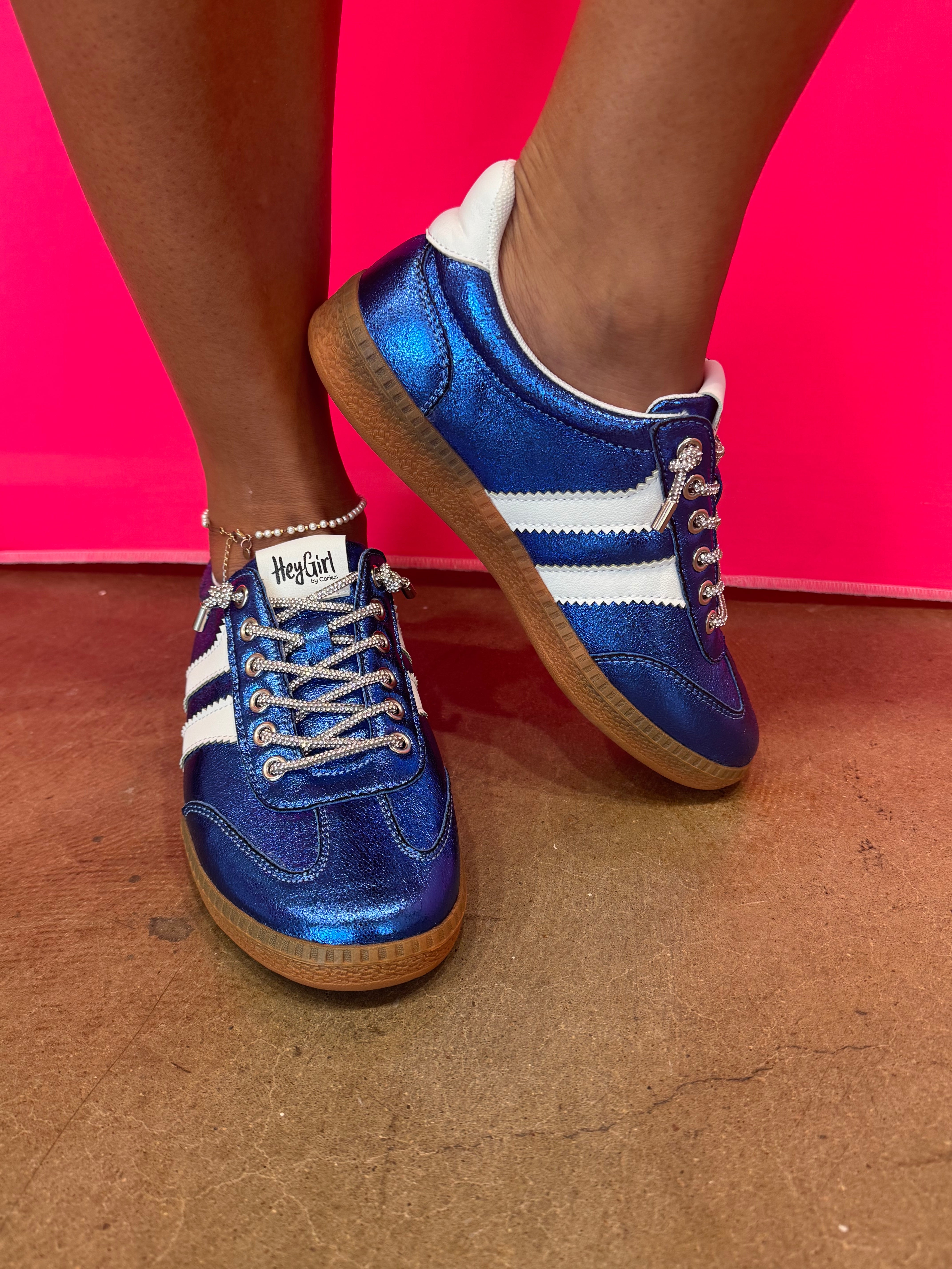 Blue metallic Corky's sneakers with white side stripes and lace-up closure.