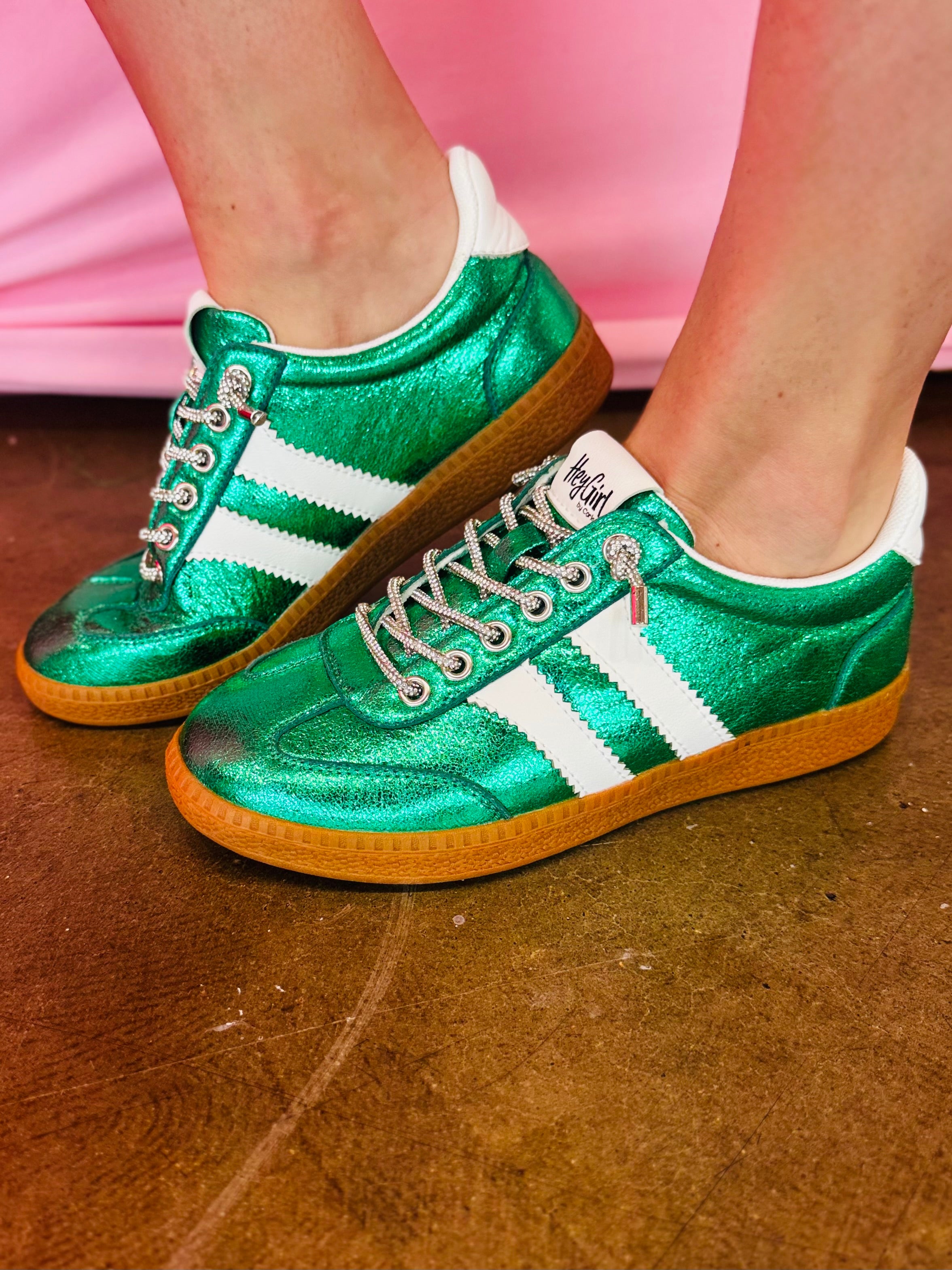 Green metallic Corky's sneakers with white side stripes and lace-up closure.