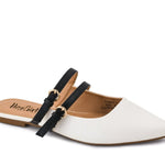 Ivory pointed-toe mule flats with black patent straps and gold buckles.
