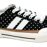 Black and white polka dot sneakers with bold side stripes and classic lace-up design