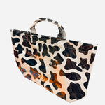 Black and white cow print tote bag with large capacity and structured durable design
