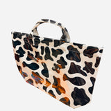 Black and white cow print tote bag with large capacity and structured durable design