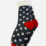 Navy polka dot sherpa-lined cabin socks with red accents and non-slip soles.