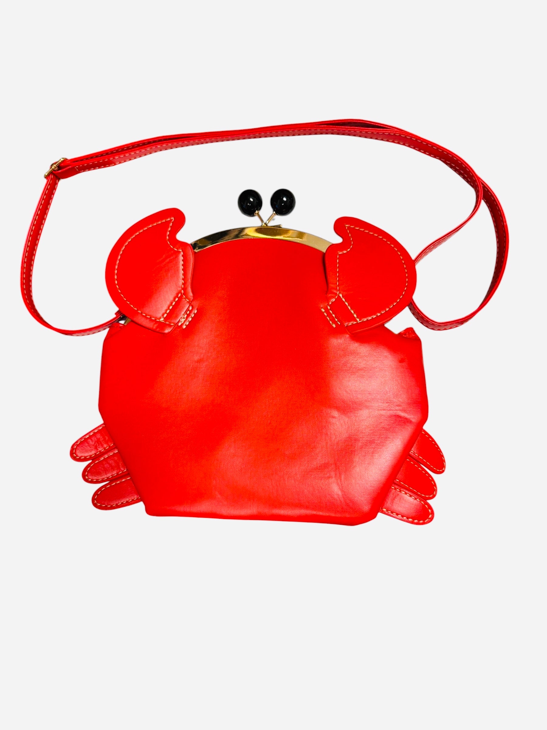 Cherry red crab shaped crossbody bag with claw details and kiss lock closure.
