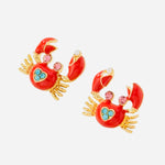 Red enamel crab stud earrings with pink and blue rhinestone accents and a pearl detail in the claw, coastal themed jewelry.
