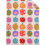 Crae Apple Patch hand towel with colorful patterned apples, gingham, florals, polka dots, and bows.