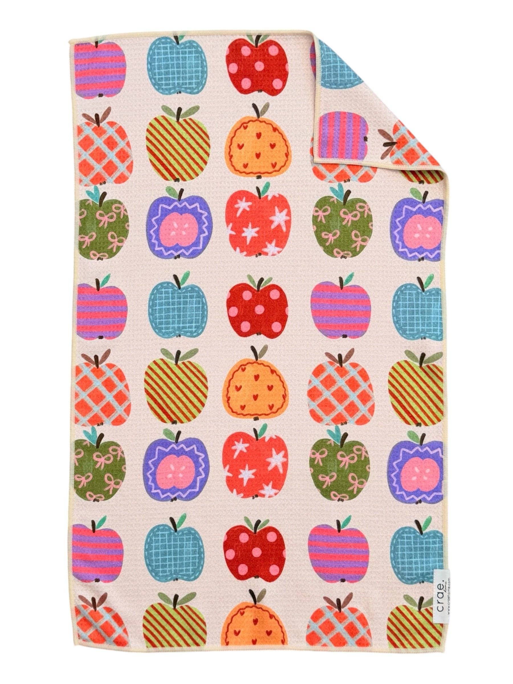 Crae Apple Patch hand towel with colorful patterned apples, gingham, florals, polka dots, and bows.
