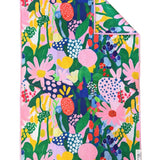 Crae Aster hand towel with colorful abstract flowers, leaves, dots, and whimsical shapes.
