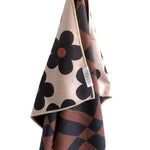 Crae Reversible hand towel with 70s floral print on one side and brown-black checkered pattern on the other.