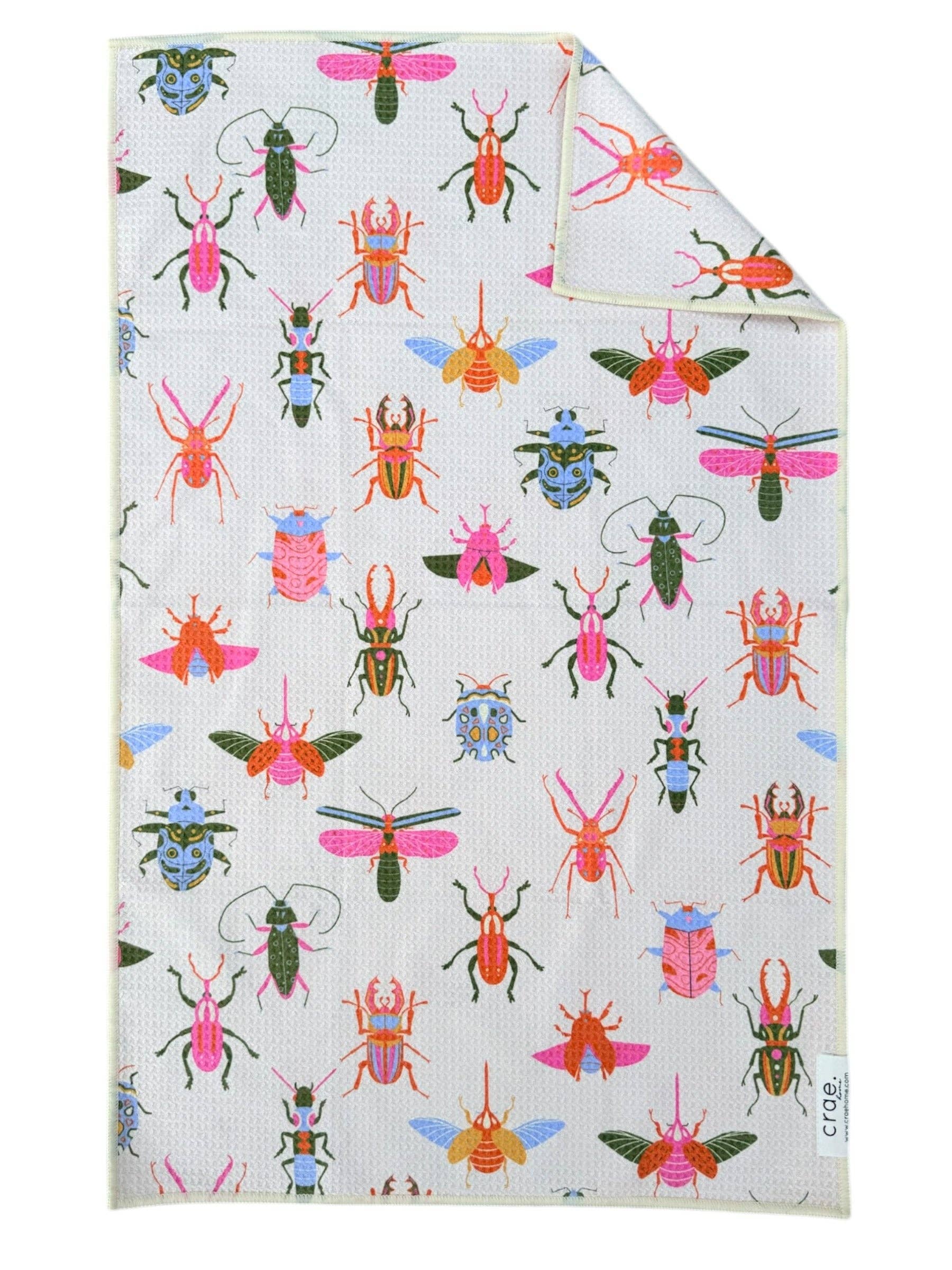 White microfiber hand towel with colorful bug print and waffle weave texture