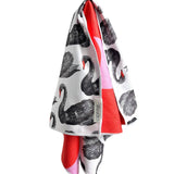 Reversible hand towel with black swans and red pink checkerboard print.