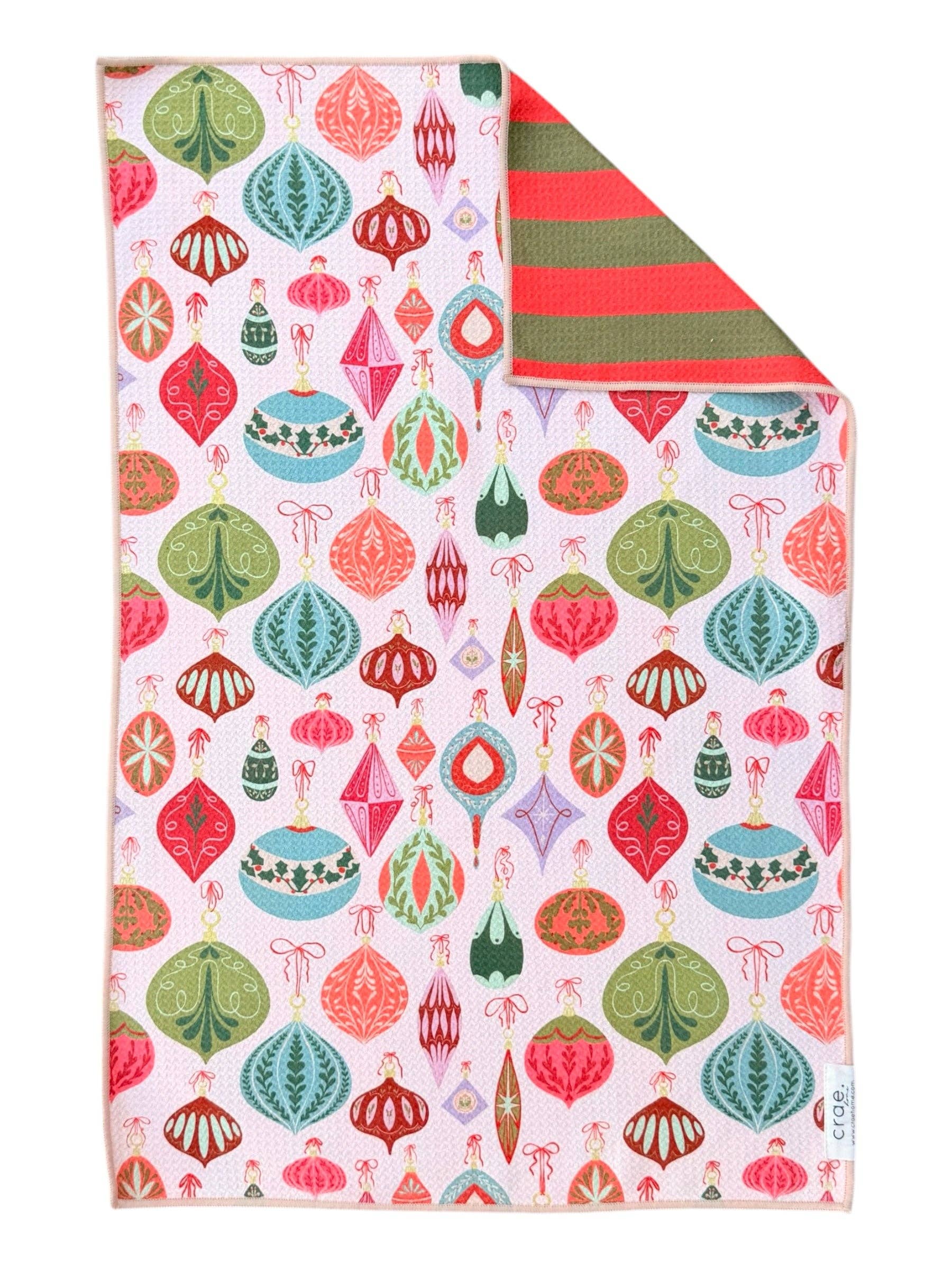 Reversible Christmas towel with red and green stripes and colorful retro ornament print.