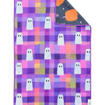 Reversible Halloween towel with white ghosts, colorful plaid and pumpkin print.