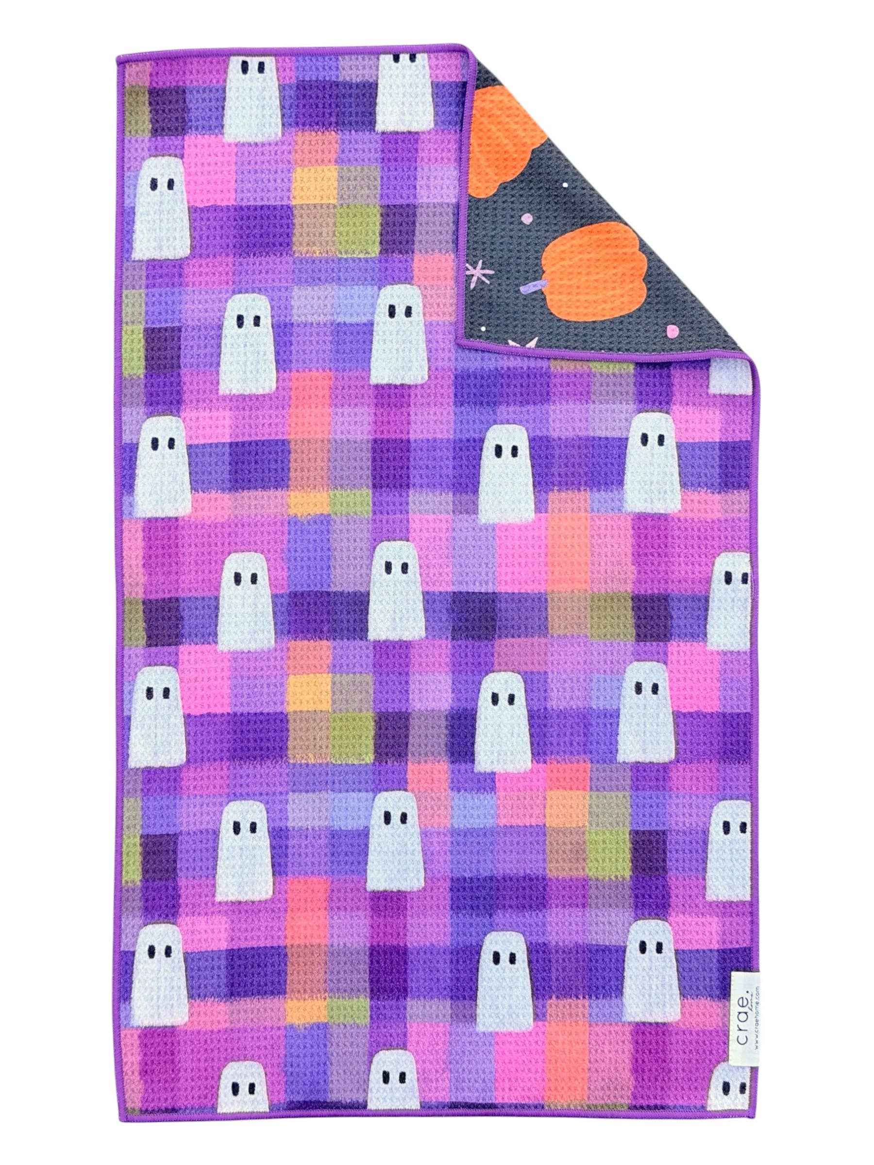 Reversible Halloween towel with white ghosts, colorful plaid and pumpkin print.