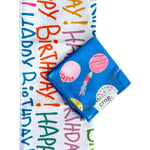 Crae birthday towel set with colorful Happy Birthday lettering and blue balloon-print washcloth.