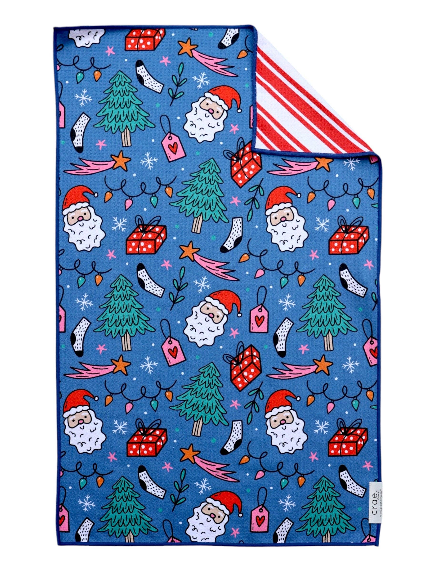 Reversible Christmas towel with colorful holiday graphics and classic red and white striped reverse.