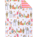 Reversible Christmas towel with colorful Nativity scene and pink striped reverse with gold starbursts.