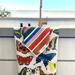 Butterfly hand towel and colorful striped washcloth set in vibrant jewel tones.