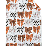 Crae White double-sided hand towel with orange, black, and white game day bow pattern.