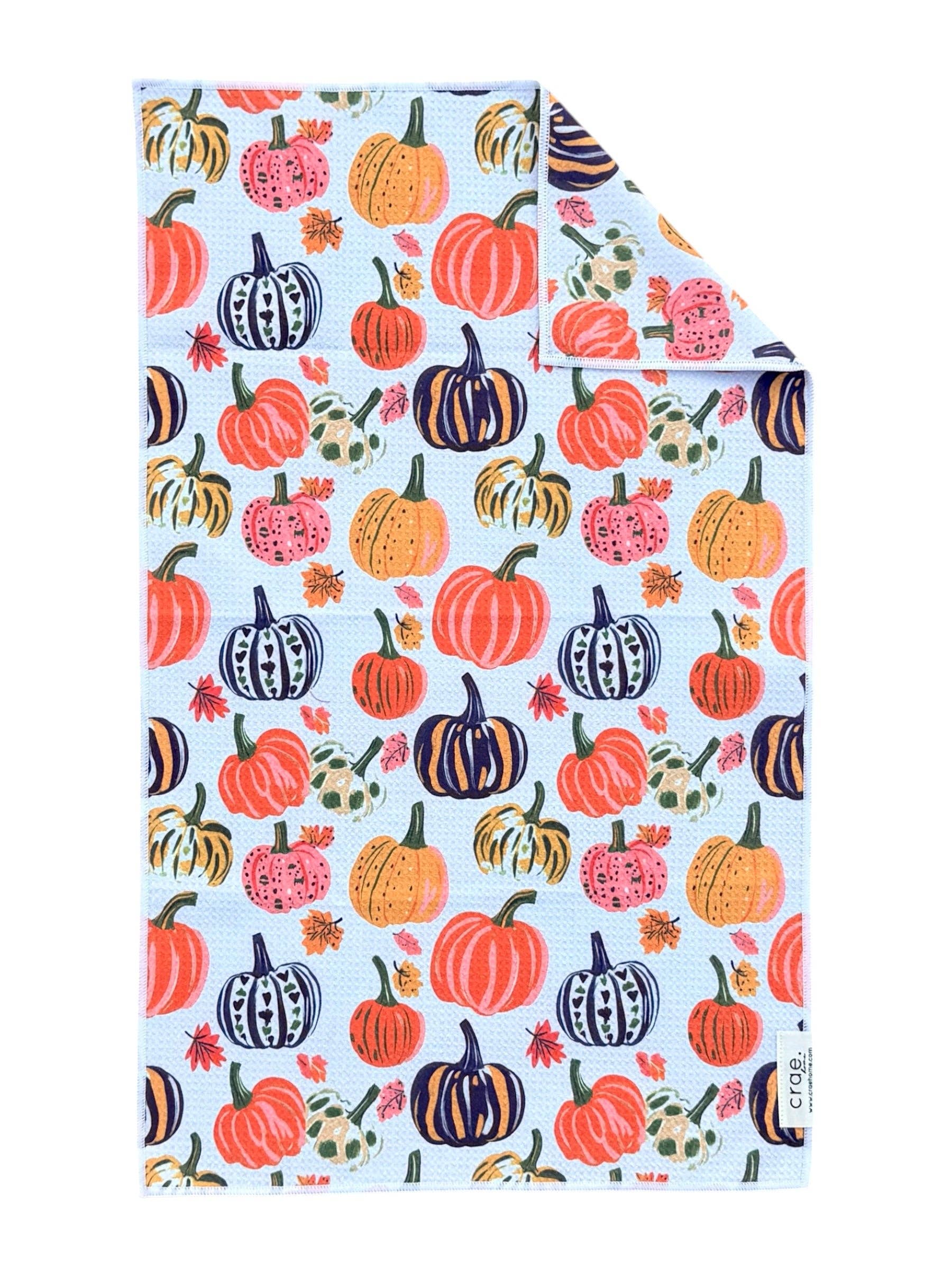 Double-sided fall hand towel with colorful orange, pink, navy, cream and yellow pumpkins.