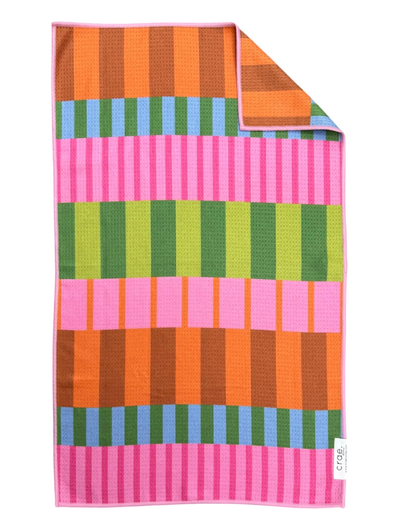 Crae Saltwater Taffy hand towel with bold pink, orange, green, blue, brown, and lime stripes.