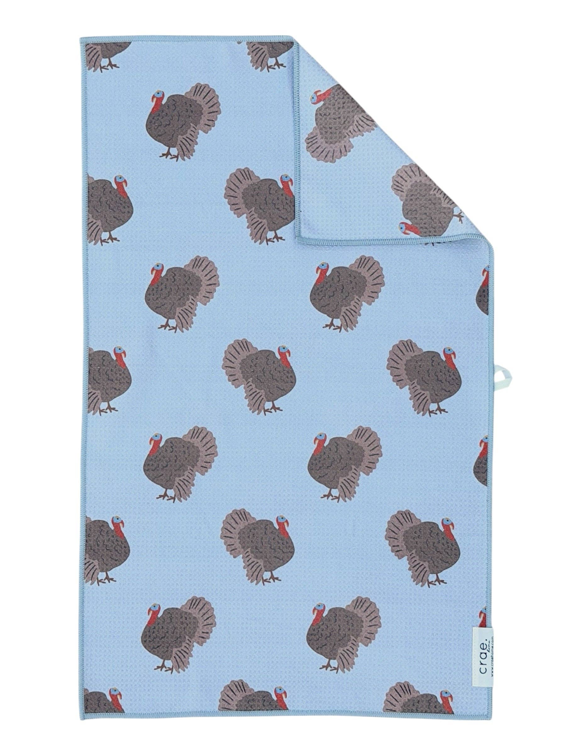 Blue double-sided hand towel with colorful allover turkey print.