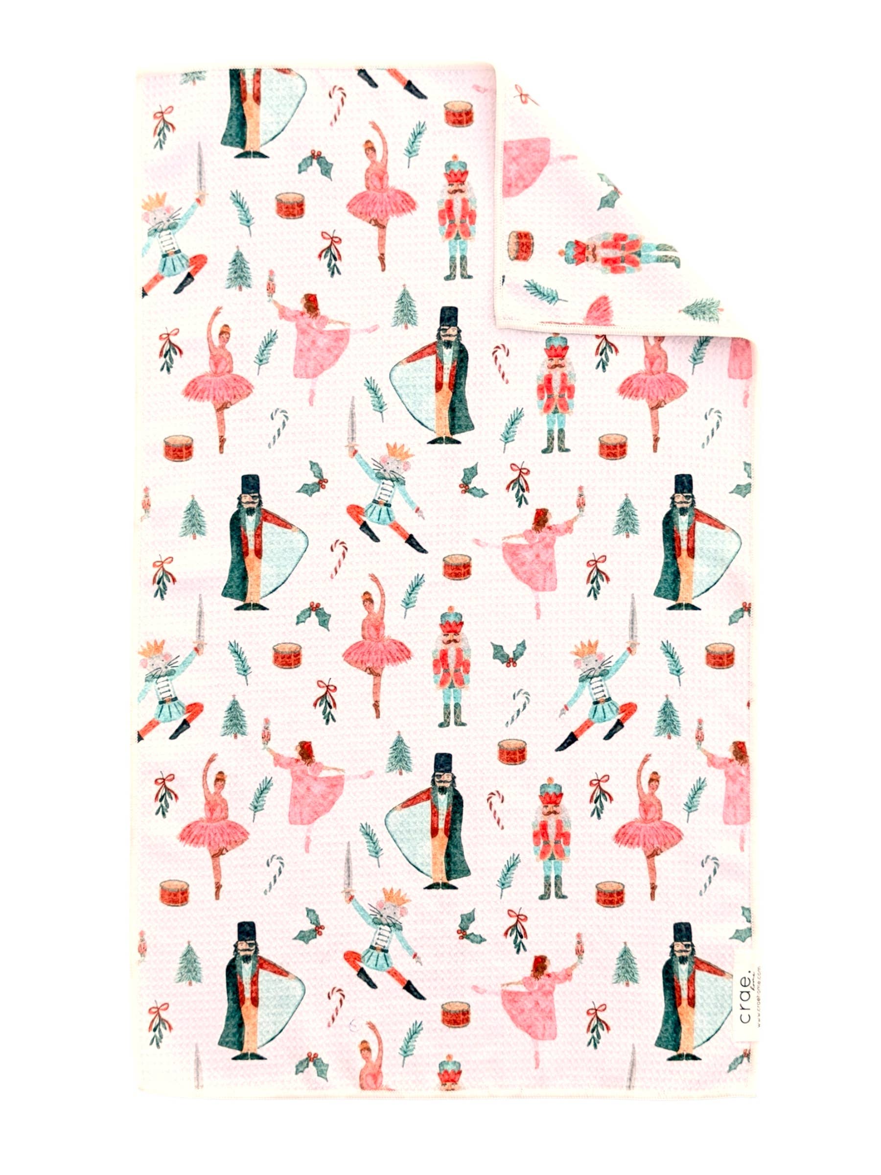 White Christmas towel with watercolor ballerinas, nutcrackers, toy soldiers, candy canes, and presents.
