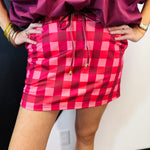 Cranberry and pink gingham skort with built-in shorts, drawstring waist, and pockets.