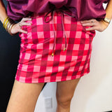 Cranberry and pink gingham skort with built-in shorts, drawstring waist, and pockets.