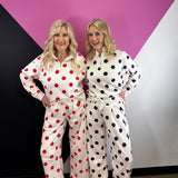 Cream barrel-leg pants with bold black polka dots and elastic waistband.