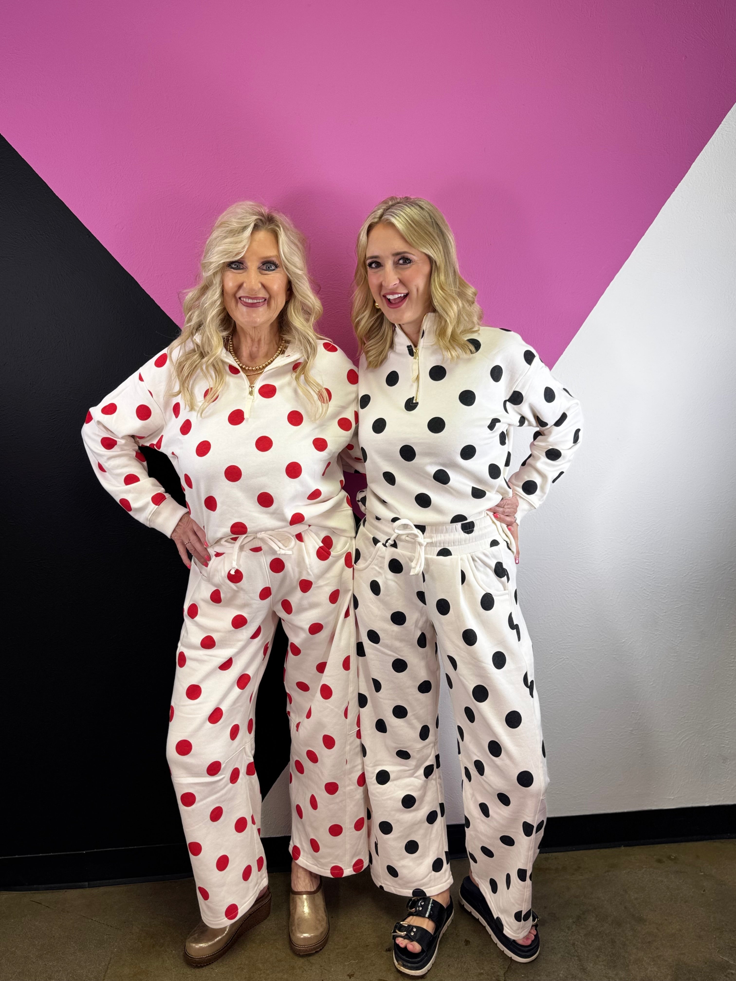 Cream barrel-leg pants with bold black polka dots and elastic waistband.