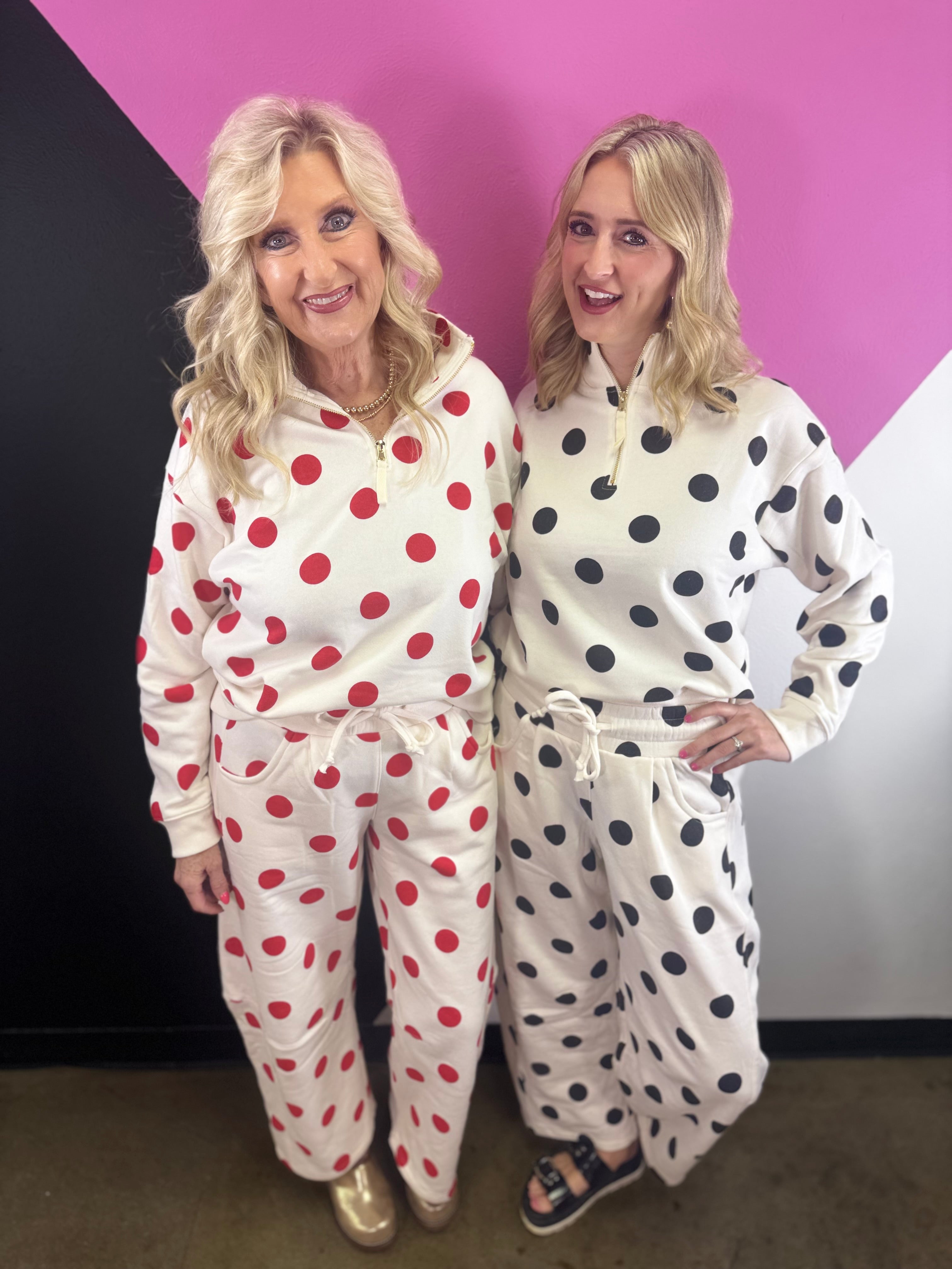 Cream quarter-zip pullover with black polka dots, long sleeves, and ribbed cuffs and hem.